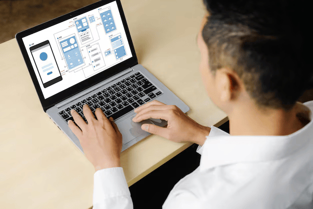 User analyzing software interface on laptop, software product development services, software development services, custom software development services